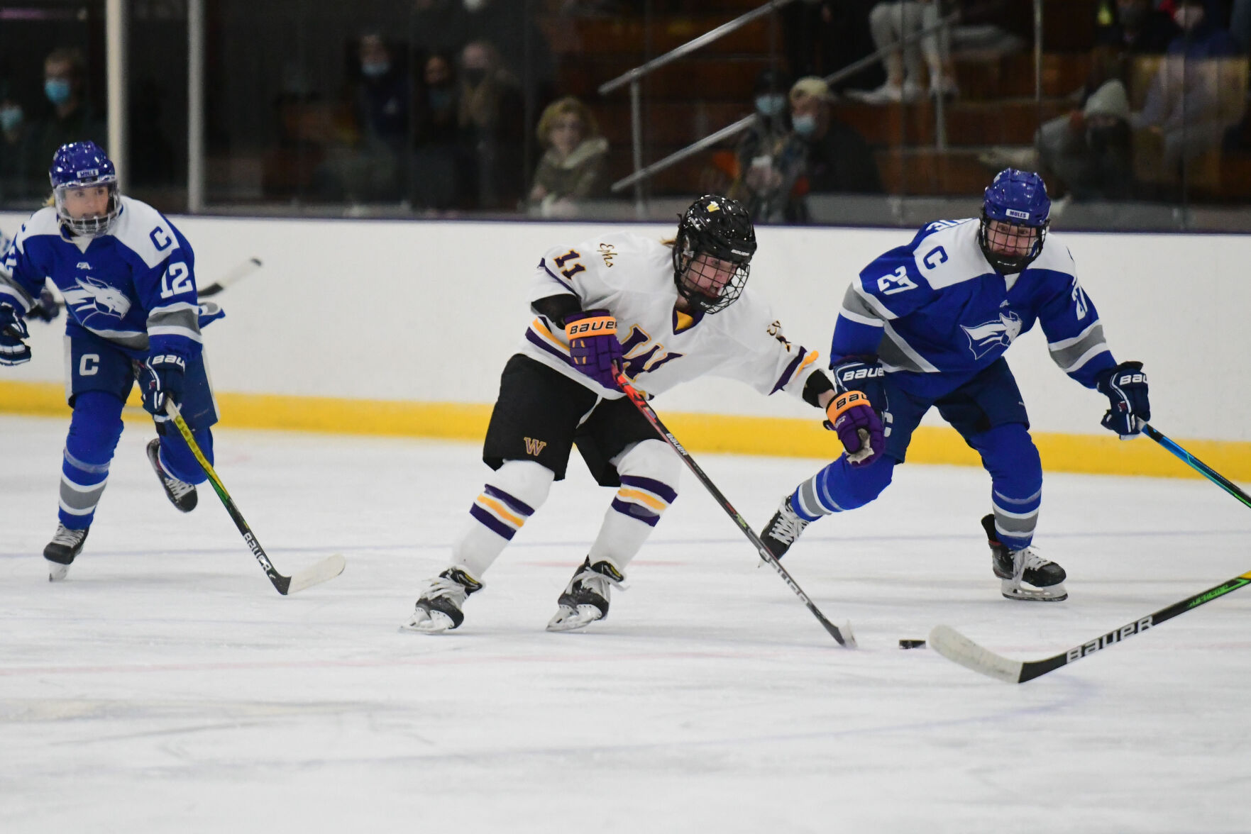 Two players battle for the puck